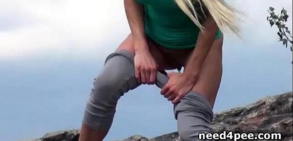  Sporty blonde gets down for a piss on the rocks
